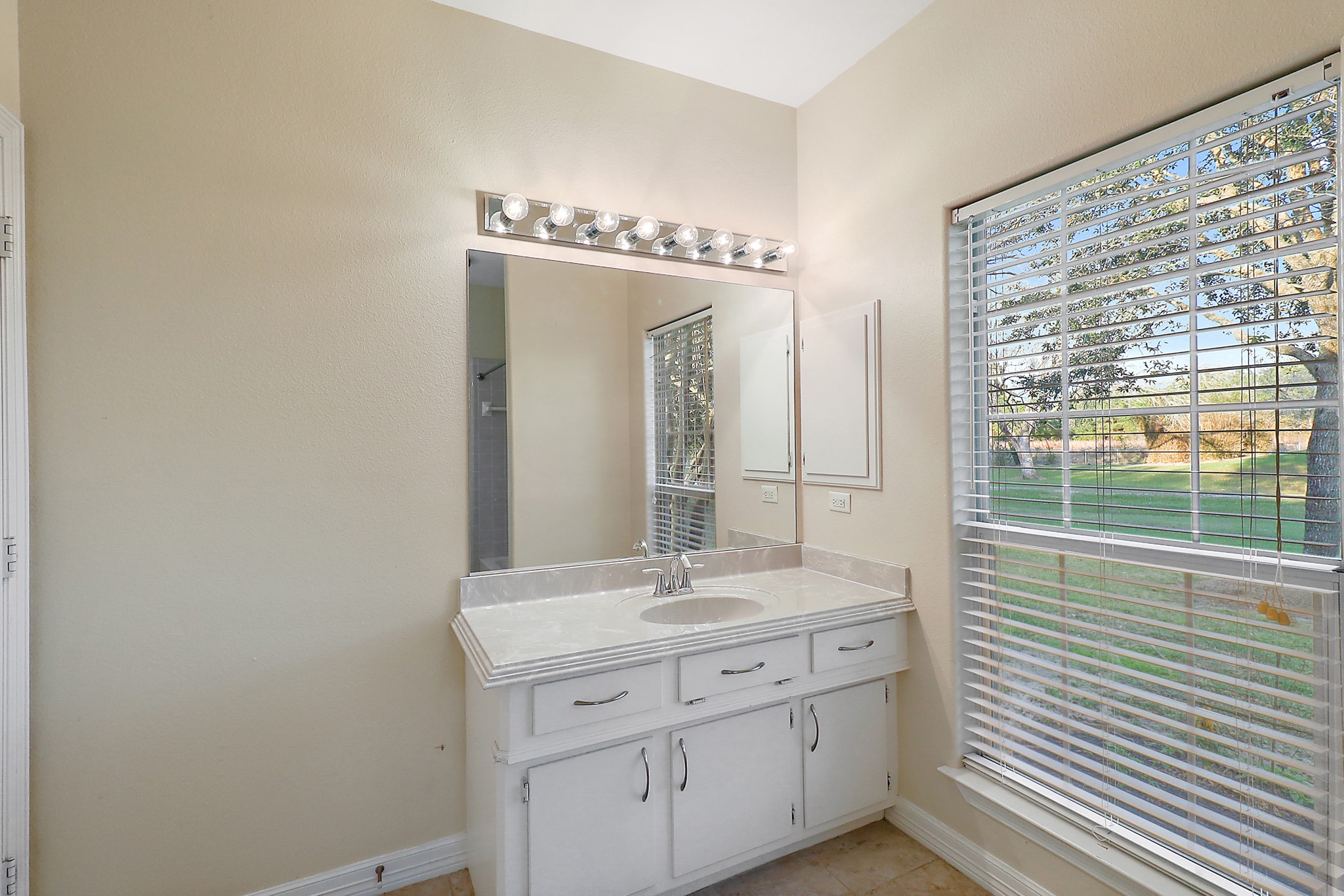 4521 West Bayshore Road, Unit A Anahuac, TX 77514 - Photo 19 of 34 a bathroom with a granite countertop sink and a mirror