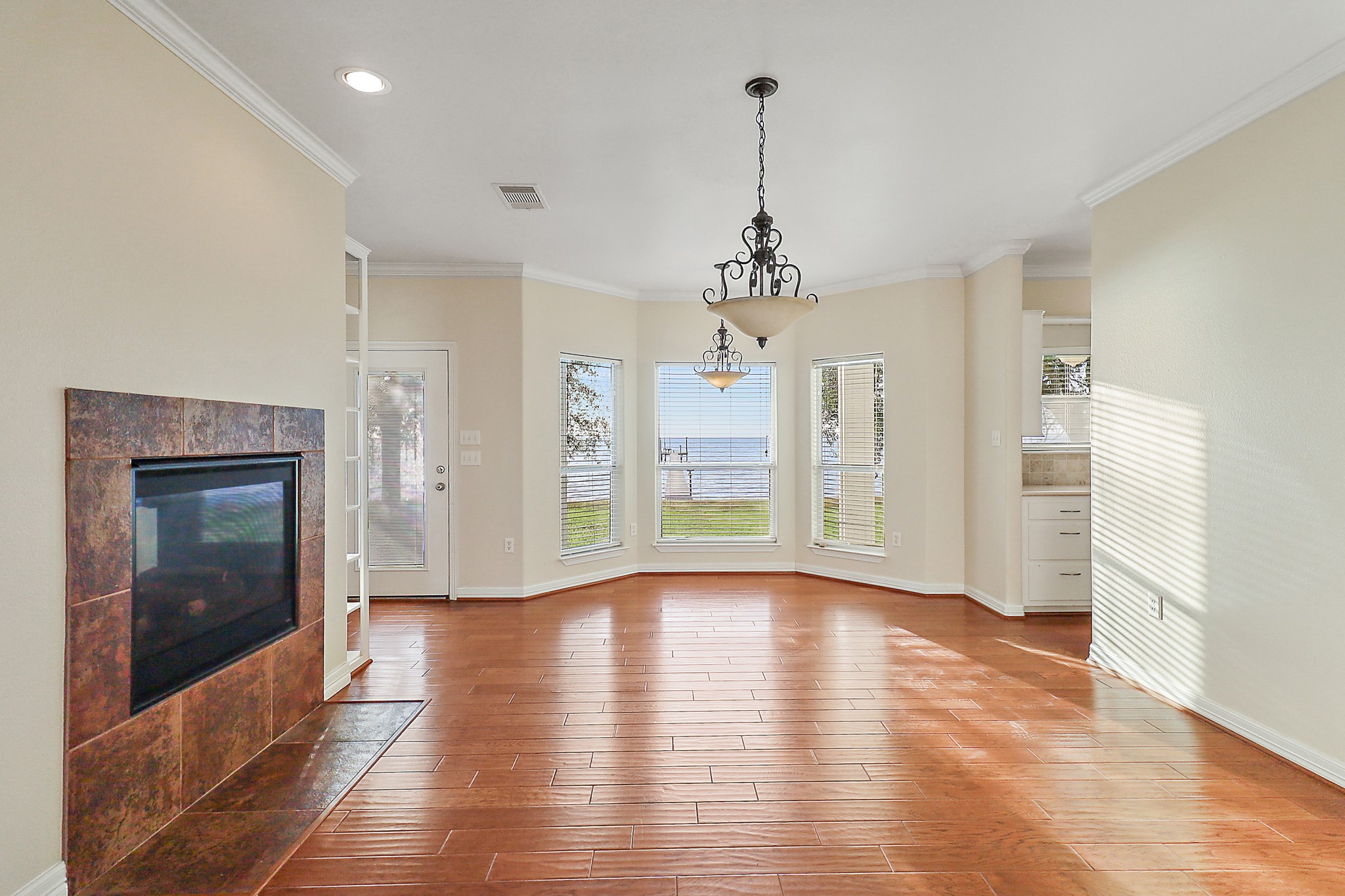 4521 West Bayshore Road, Unit A Anahuac, TX 77514 - Photo 21 of 34 a view of a room with wooden floor fireplace and windows