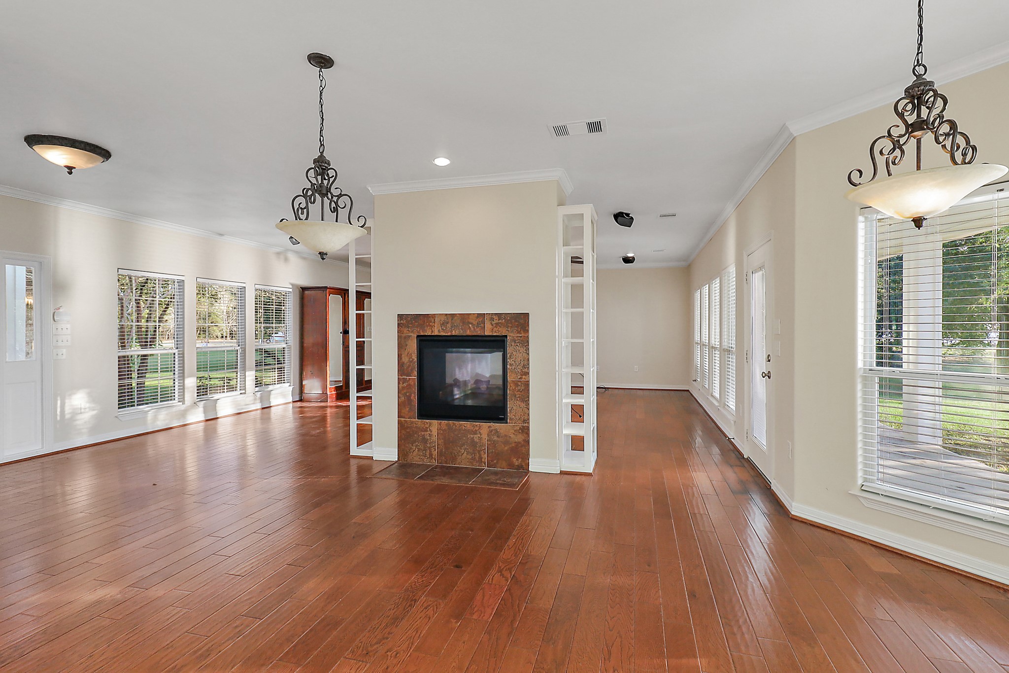 4521 West Bayshore Road, Unit A Anahuac, TX 77514 - Photo 22 of 34 a view of a room with wooden floor fireplace and windows