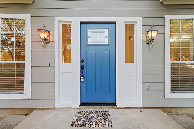 a view of a house with a big yard and large trees