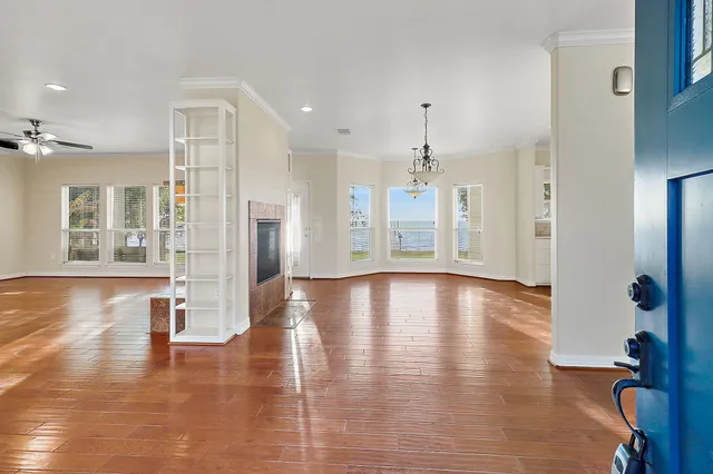 a view of a room with wooden floor staircase and a kitchen