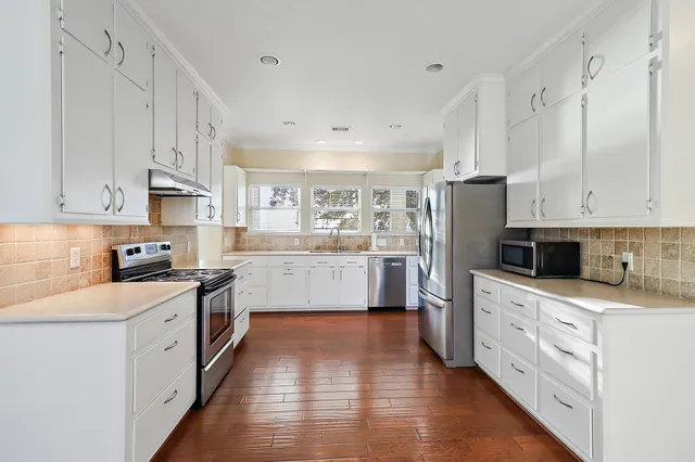 a kitchen with a sink cabinets and window