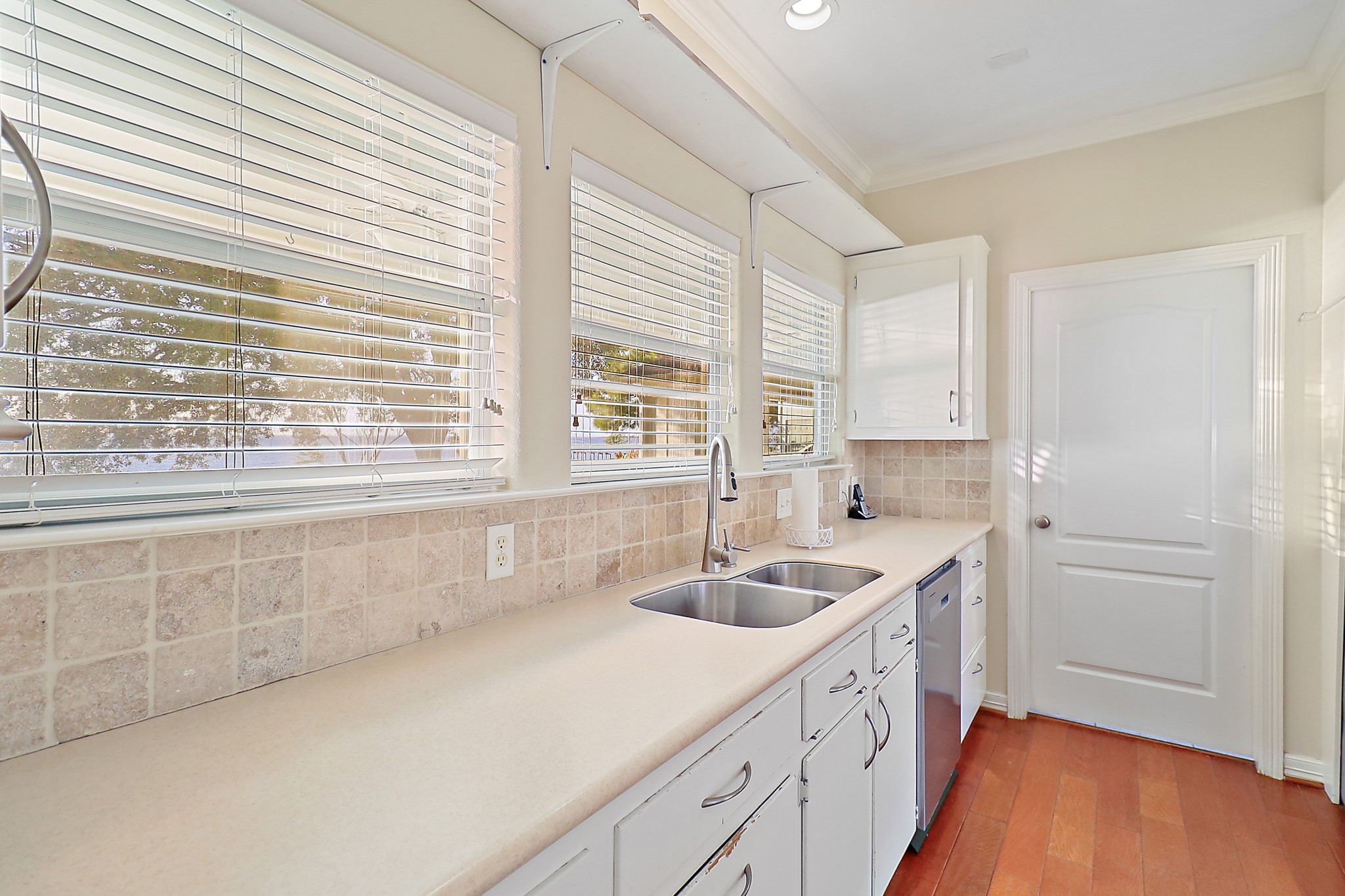4521 West Bayshore Road, Unit A Anahuac, TX 77514 - Photo 8 of 34 a kitchen with a sink cabinets and window
