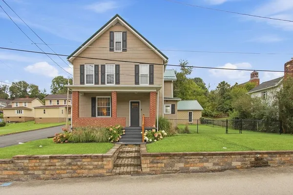 a front view of a house with a yard
