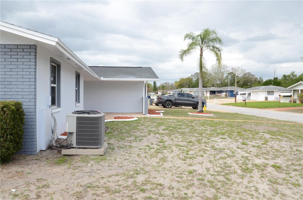 10433 Laburnum Drive Port Richey, FL 34668 - Photo 4 of 26 a backyard of a house with table and chairs