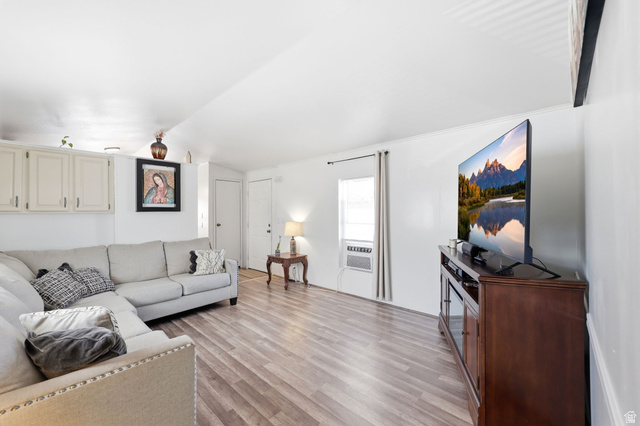 1525 South 400 East, Unit 13 Springville, UT 84663 - Photo 11 of 32 Open-concept living space with wood-finish flooring, white walls, and bright natural light