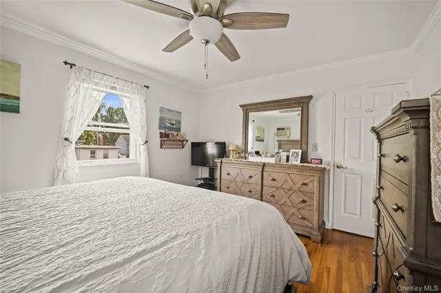 a bedroom with a bed dresser and a window