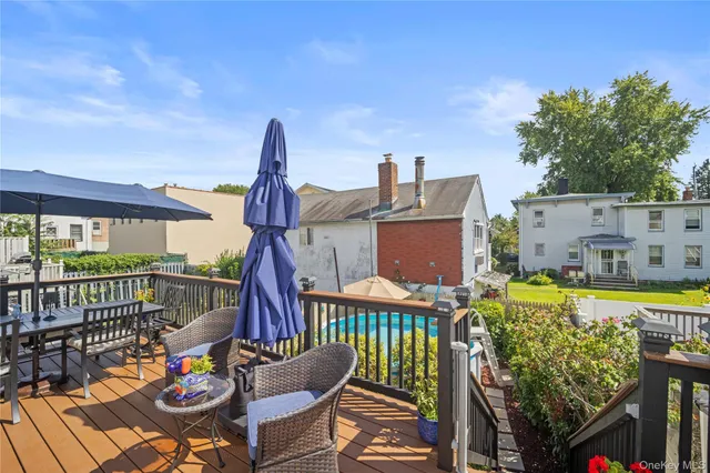 a view of a deck with furniture and barbeque grill