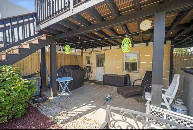 a building outdoor space with patio furniture and potted plants