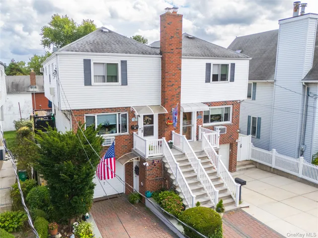 a front view of a house with garden and plants
