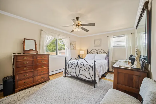 a bedroom with a bed and a dresser with the mirror