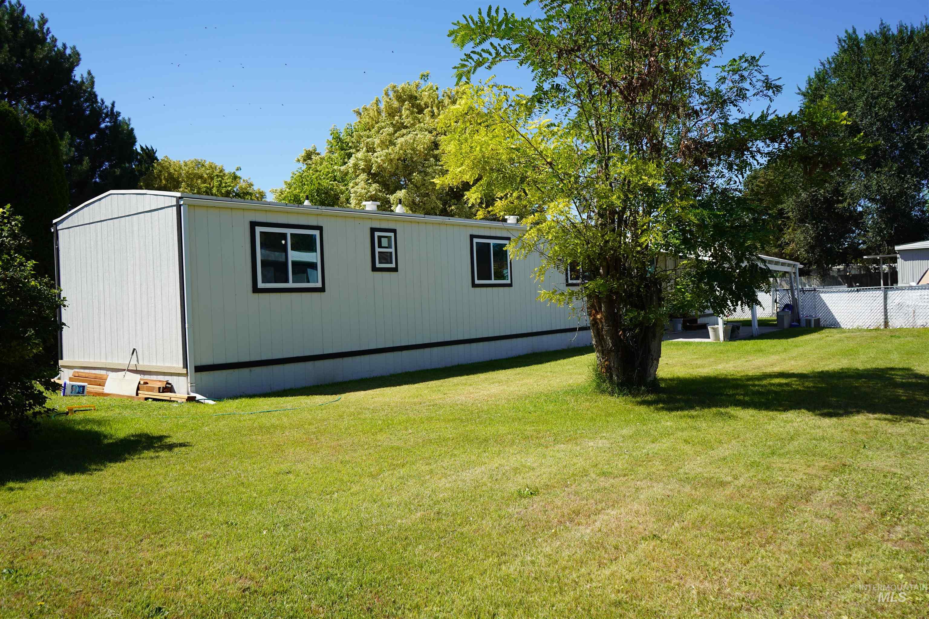 5015 East Ustick Road, Unit 81 Caldwell, ID 83605 - Photo 2 of 13 View of side of home with a lawn