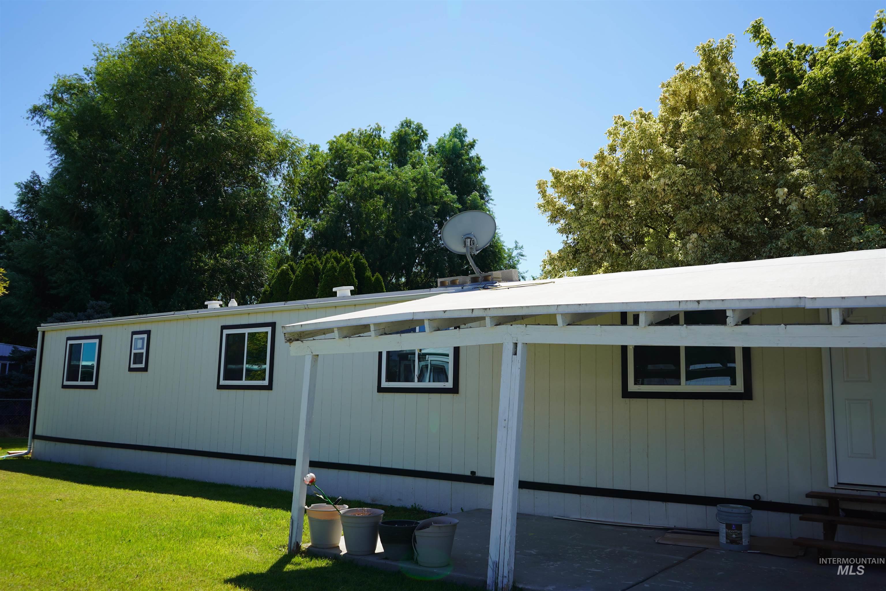 5015 East Ustick Road, Unit 81 Caldwell, ID 83605 - Photo 3 of 13 View of property exterior featuring a yard