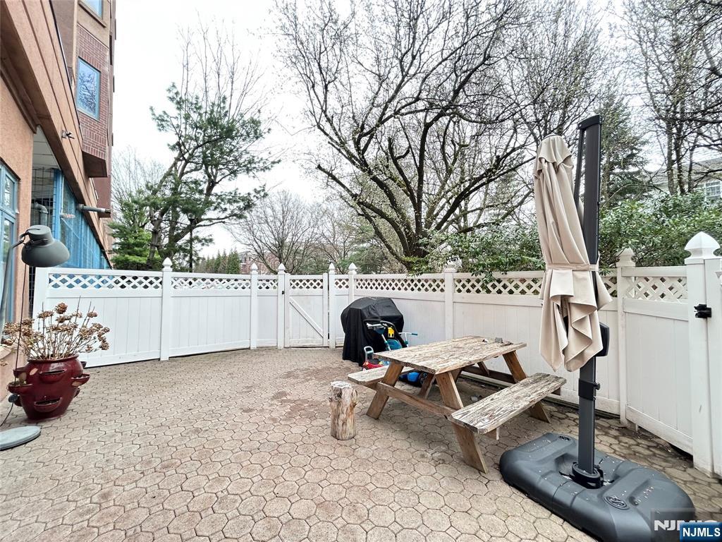 a view of a terrace with chairs and iron fence