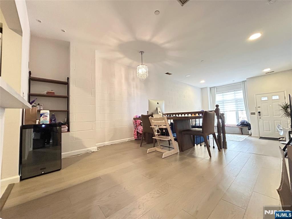 18 Independence Way, Unit J018 Edgewater, NJ 07020 - Photo 14 of 18 a dining hall with stainless steel appliances kitchen island granite countertop a table and chairs