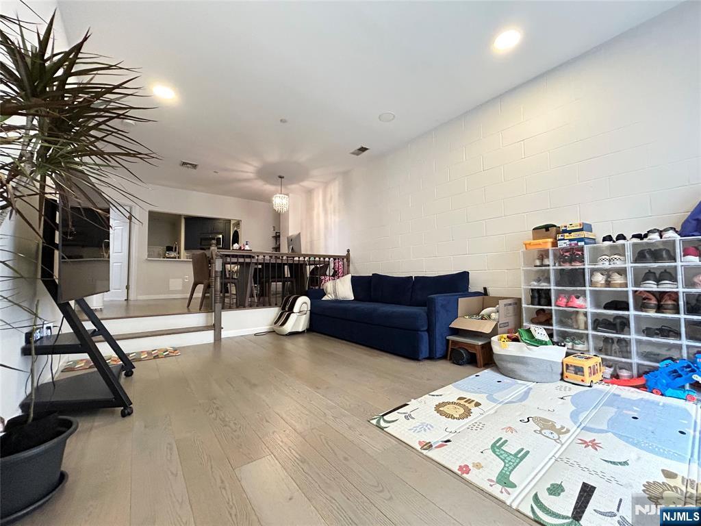 18 Independence Way, Unit J018 Edgewater, NJ 07020 - Photo 15 of 18 a living room with furniture and a flat screen tv