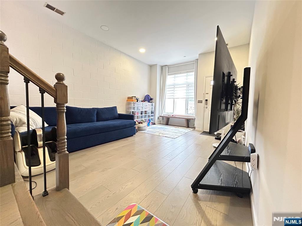18 Independence Way, Unit J018 Edgewater, NJ 07020 - Photo 17 of 18 a living room with furniture and a flat screen tv