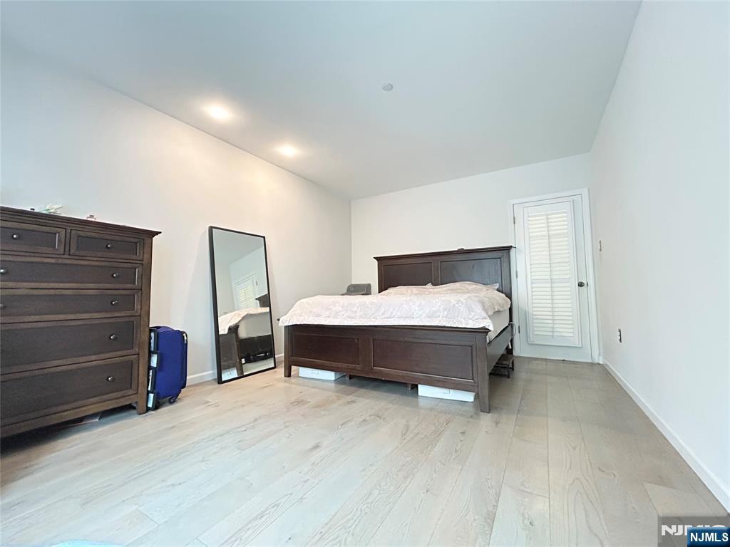 18 Independence Way, Unit J018 Edgewater, NJ 07020 - Photo 9 of 18 a spacious bedroom with a bed and a dresser