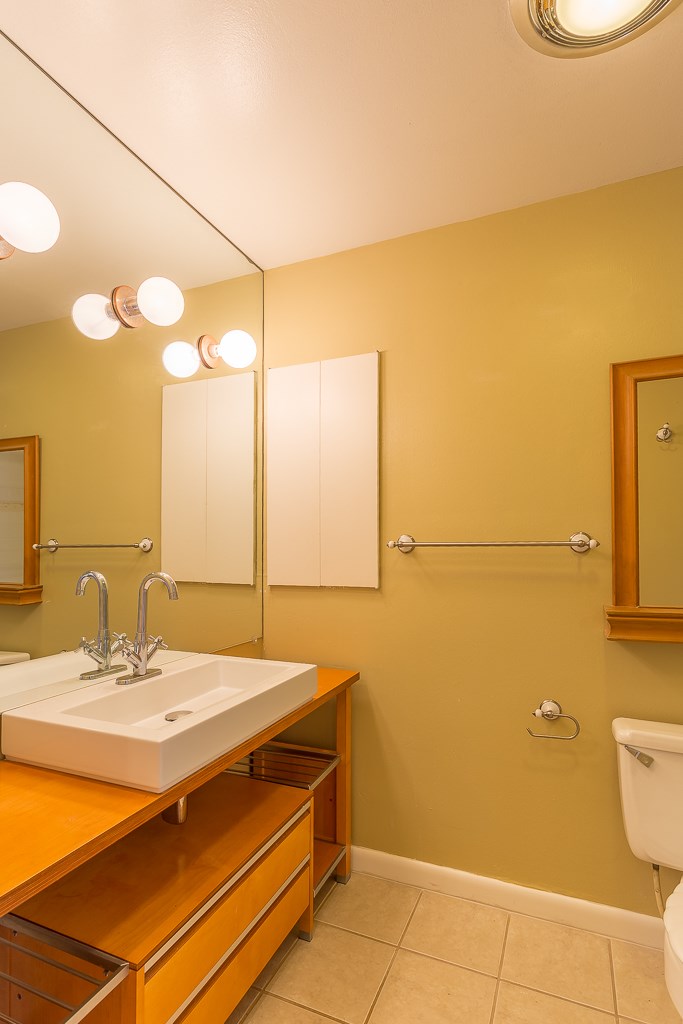 2349 Albans Road, Unit 2 Houston, TX 77005 - Photo 19 of 25 This en-suite master bath offers a warm and inviting retreat with its modern vanity, ample lighting, and sleek fixtures, perfect for unwinding in style.