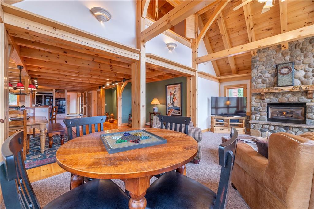 1202 Tiger Road Breckenridge, CO 80424 - Photo 11 of 35 a dining room with furniture a fireplace and wooden floor