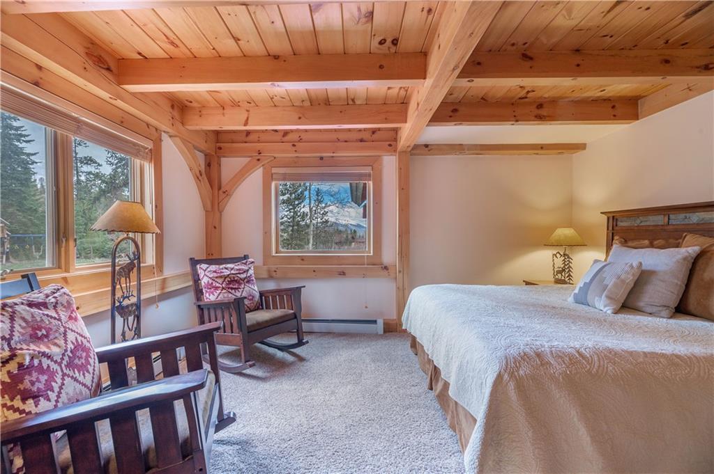 1202 Tiger Road Breckenridge, CO 80424 - Photo 12 of 35 a bedroom with a bed next to a window