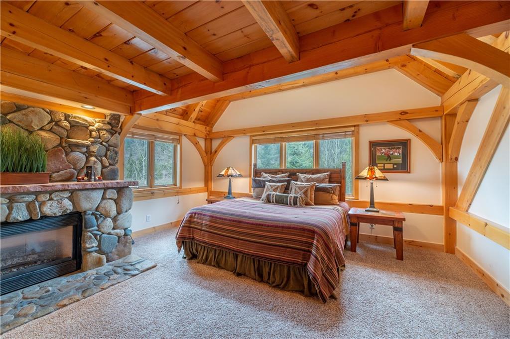 1202 Tiger Road Breckenridge, CO 80424 - Photo 19 of 35 a bed room with a bed and a chair