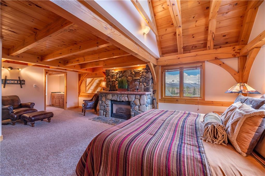 1202 Tiger Road Breckenridge, CO 80424 - Photo 20 of 35 a bed room with a bed and a chair
