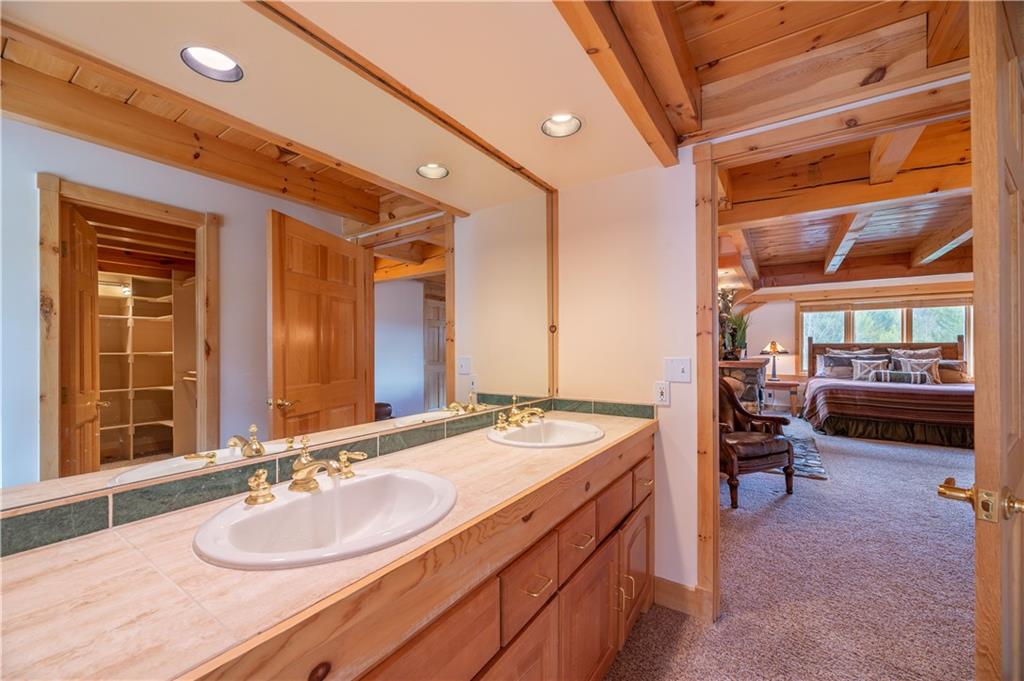 1202 Tiger Road Breckenridge, CO 80424 - Photo 23 of 35 a en suite bathroom with a double vanity sink and a mirror