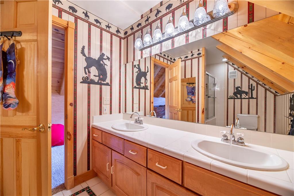 1202 Tiger Road Breckenridge, CO 80424 - Photo 28 of 35 a bathroom with a double vanity sink and a mirror