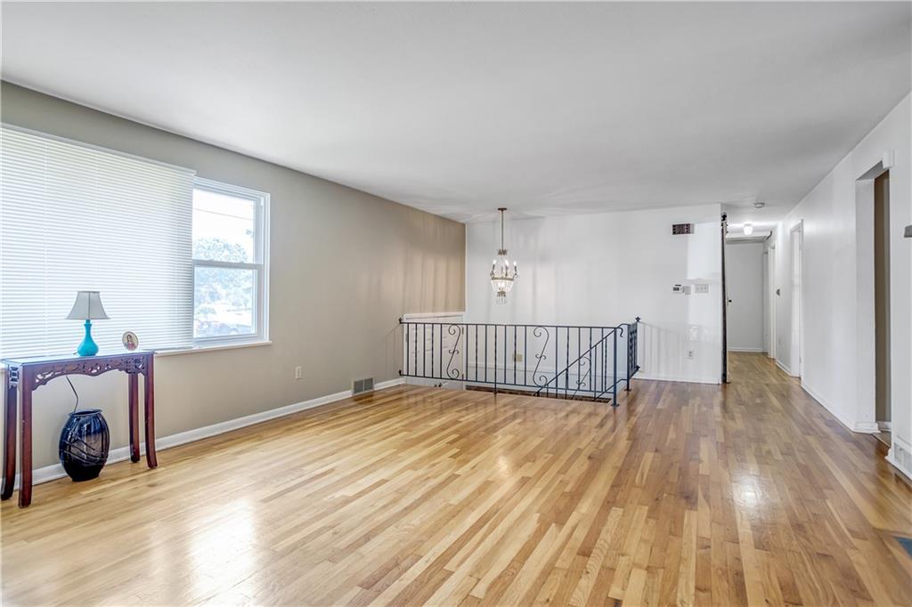 104 South Jamestown Road Coraopolis, PA 15108 - Photo 3 of 25 Gorgeous hardwood floors in living room, with wrought iron railing.