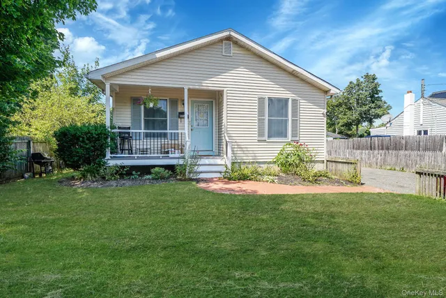 a front view of a house with a yard and table and chairs