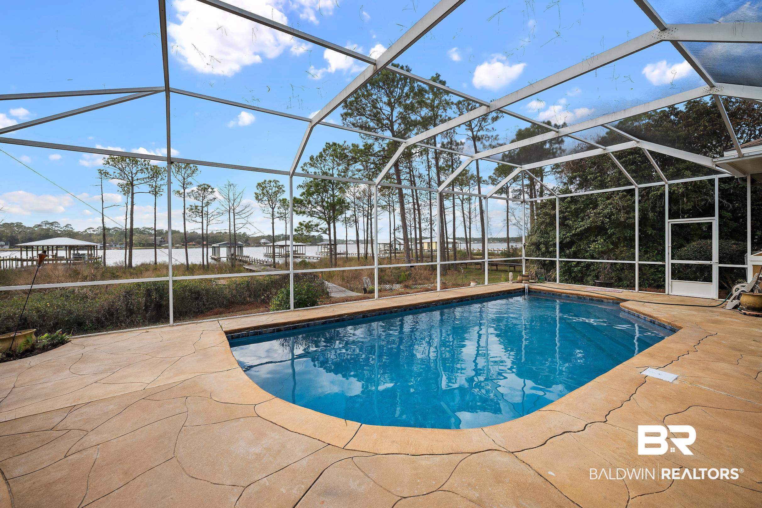 8591 Bay Harbor Road Elberta, AL 36530 - Photo 13 of 56 Swimming pool featuring a sunroom, a lanai, and a patio area