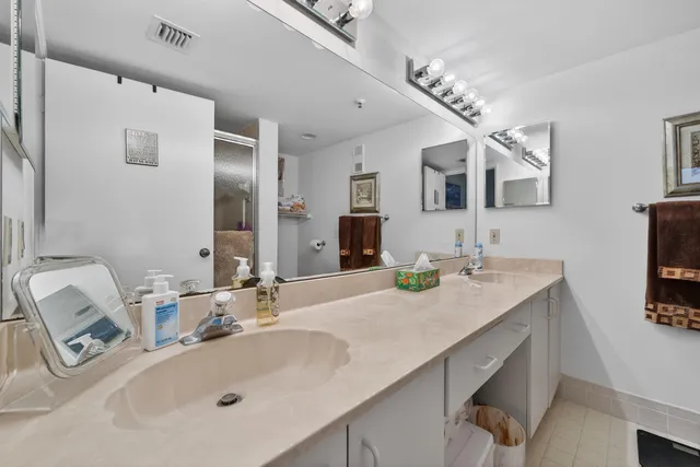 a bathroom with a sink double vanity and a mirror