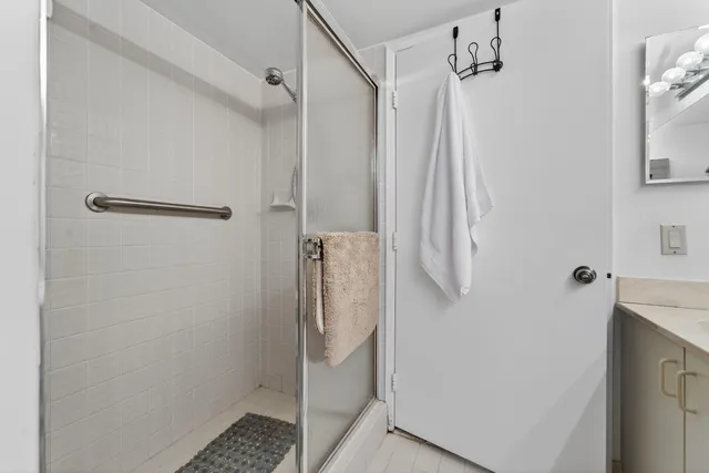 a bedroom with two beds and a chandelier