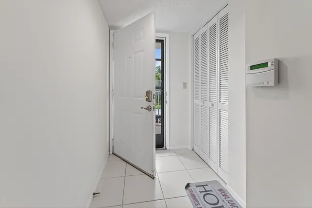 a view of a brick house with a yard and plants