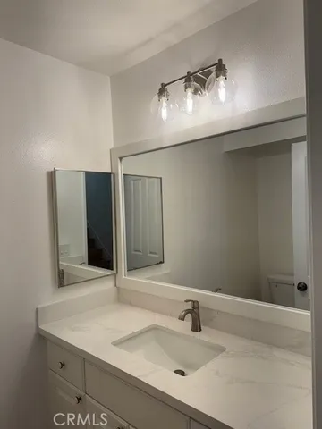 a kitchen with granite countertop cabinets stainless steel appliances and wooden floor