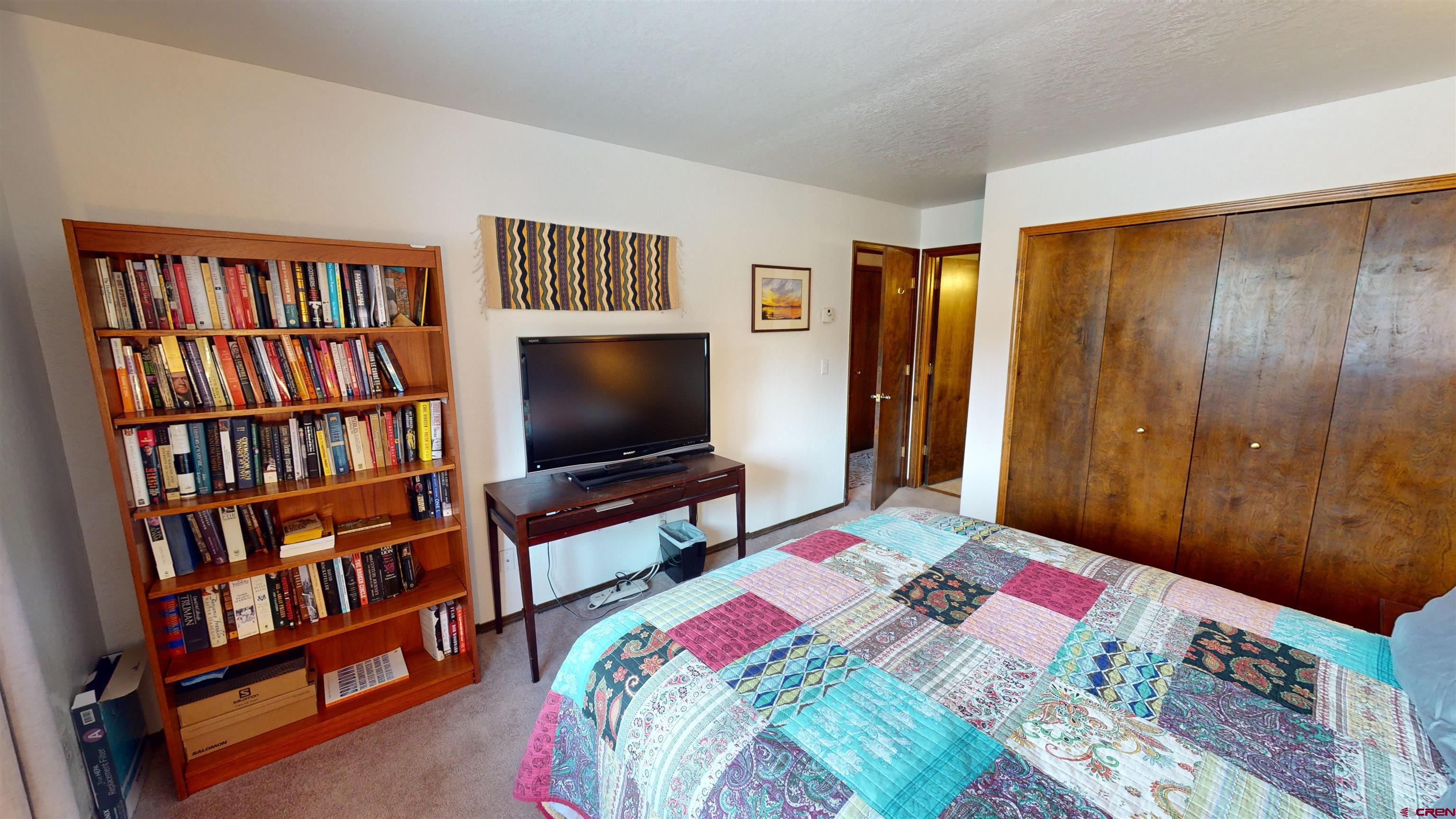 232 Pine Ridge Loop Durango, CO 81301 - Photo 16 of 35 a bedroom with a bed and a book shelf