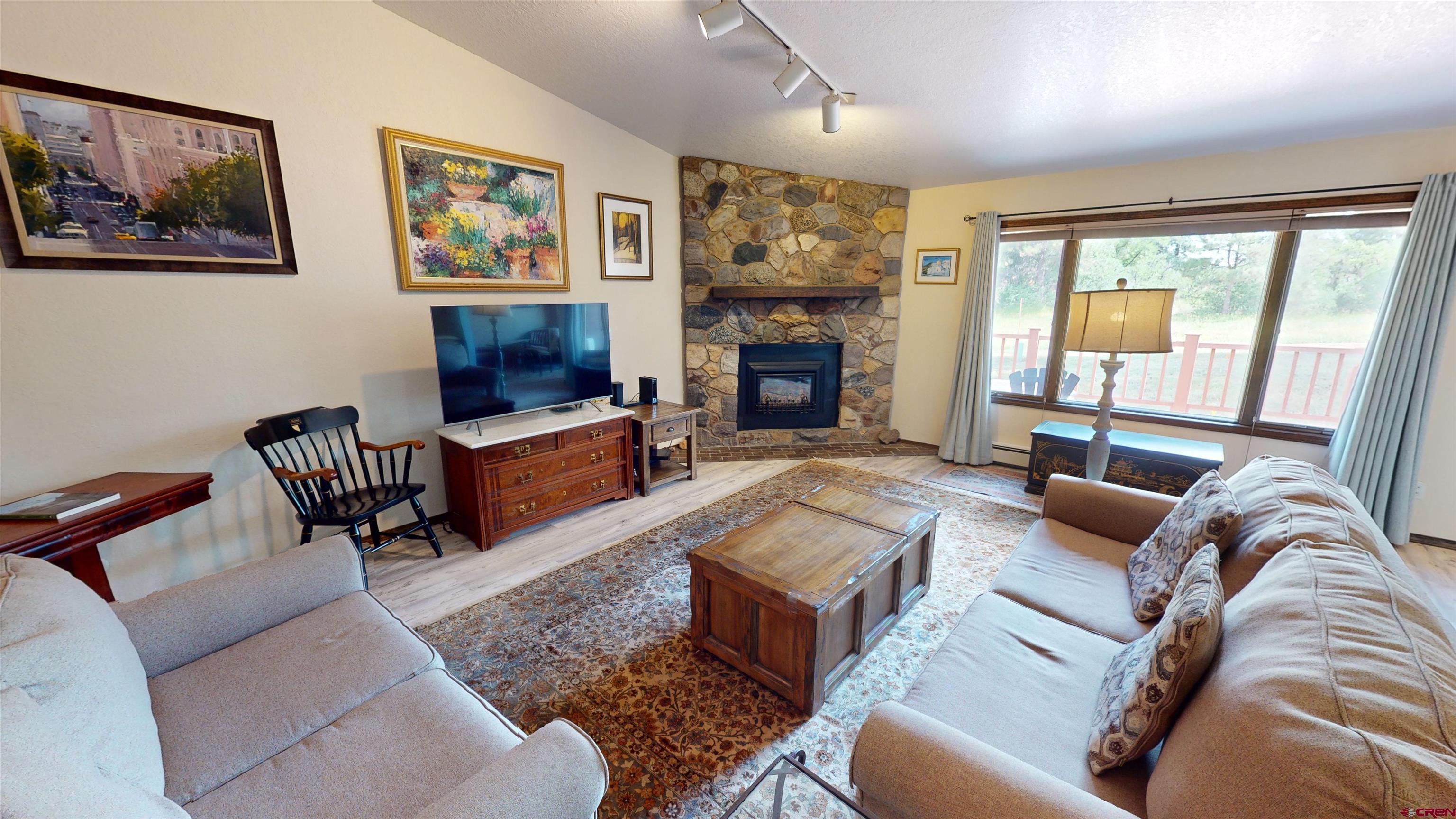 232 Pine Ridge Loop Durango, CO 81301 - Photo 4 of 35 a living room with furniture large window and a fireplace