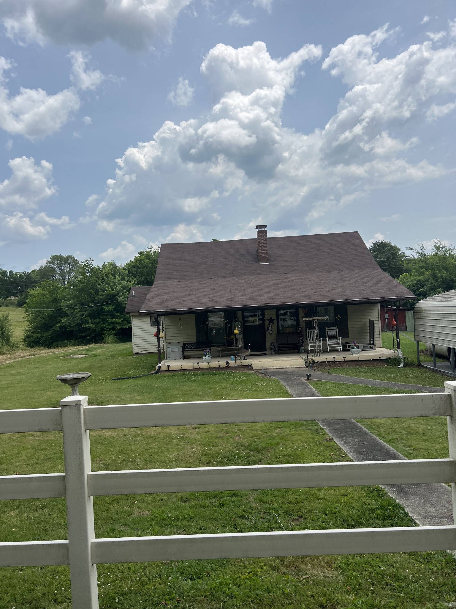 4629 Southeast Tater Peeler Road Lebanon, TN 37090 - Photo 7 of 11 a view of a white house in a big yard with a fountain