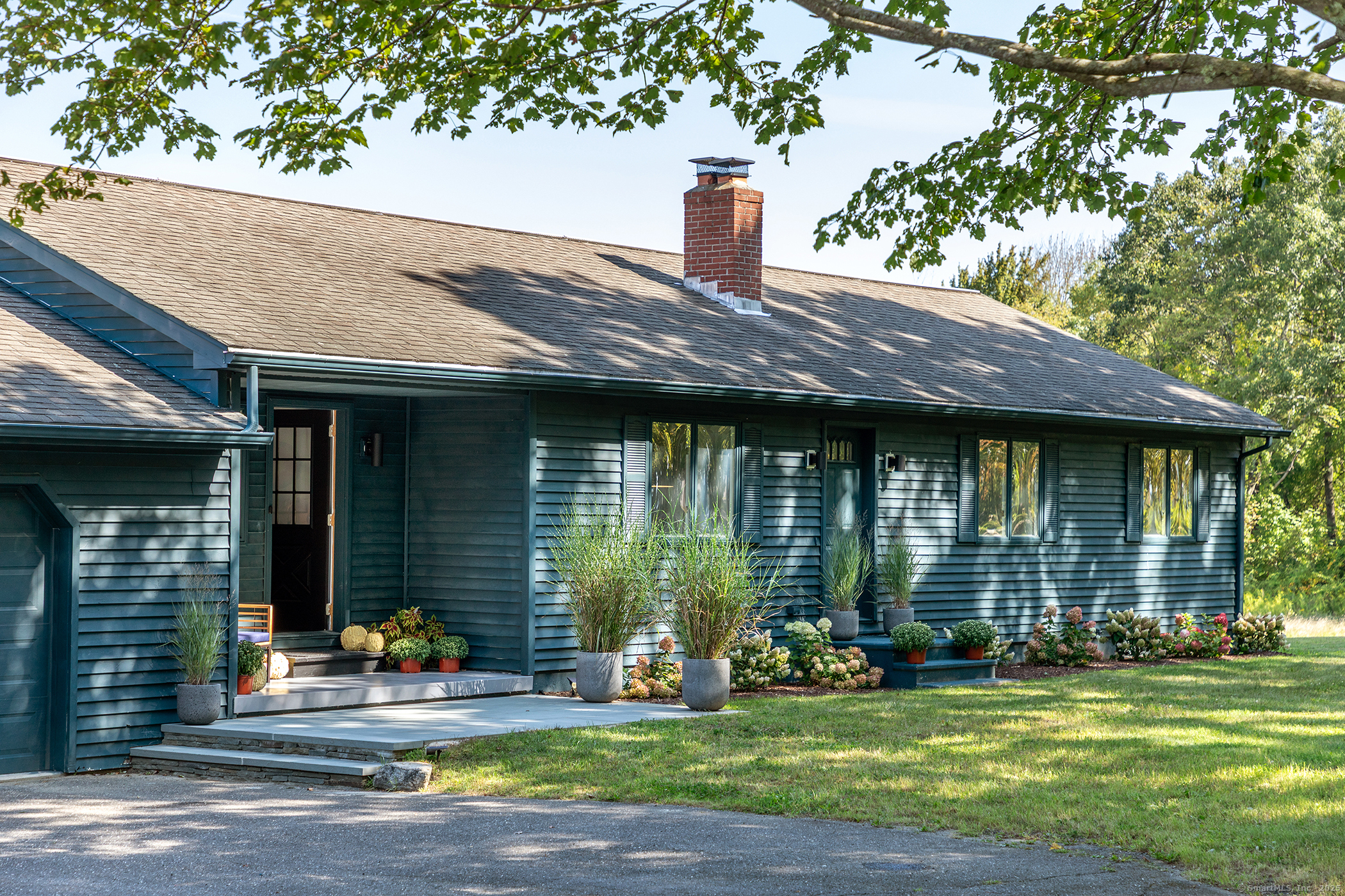 a backyard of a house with yard and outdoor seating
