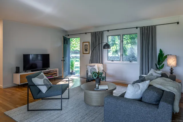 a bedroom with a bed lamp and a window