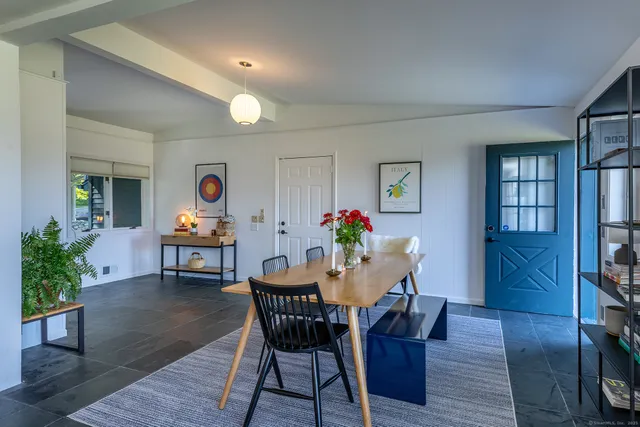 a dining room with furniture and wooden floor
