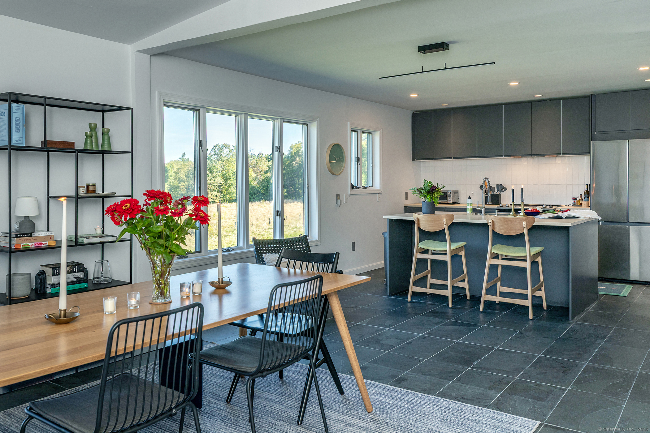 10 Surdan Mountain Road Sharon, CT 06069 - Photo 5 of 31 a view of a dining room with furniture and a potted plant