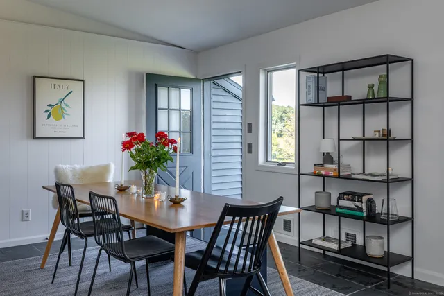 a view of a dining room with furniture and window