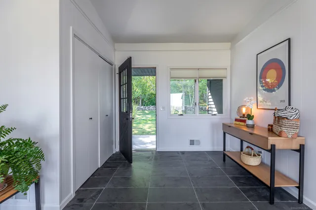 a dining table with chairs and window