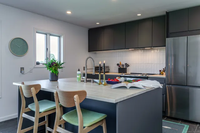 a kitchen with a dining table chairs and view kitchen
