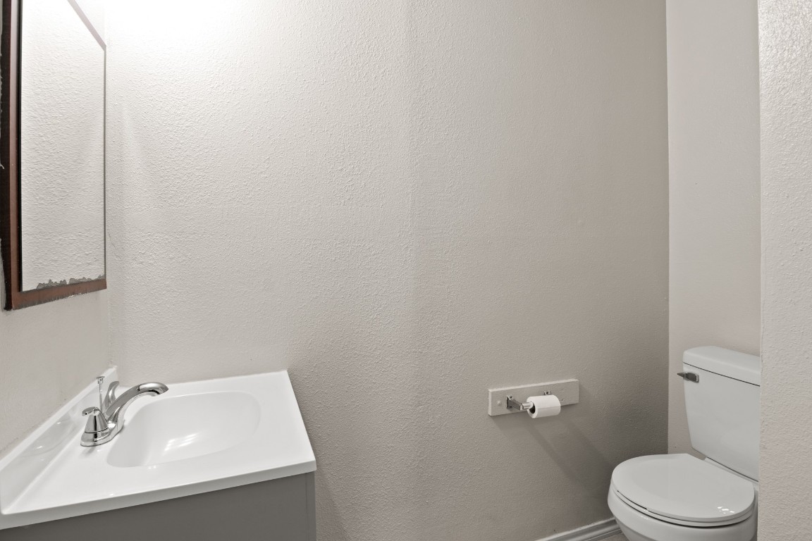 23393 Nameless Road, Unit 160 Leander, TX 78641 - Photo 16 of 20 a bathroom with a sink a toilet and mirror