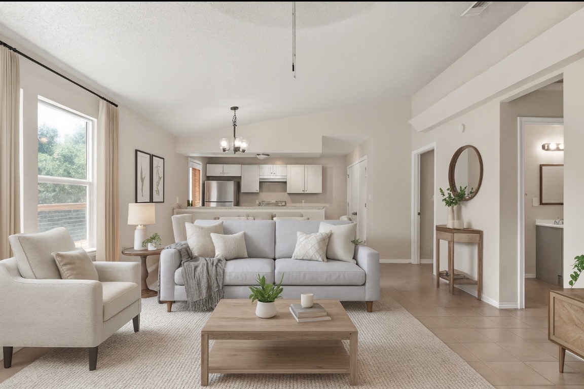 23393 Nameless Road, Unit 160 Leander, TX 78641 - Photo 20 of 20 a living room with furniture and a chandelier