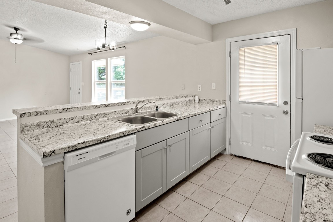 23393 Nameless Road, Unit 160 Leander, TX 78641 - Photo 10 of 20 a bathroom with a granite countertop sink and a mirror