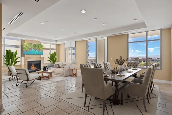 a view of a dining room with furniture large windows and wooden floor